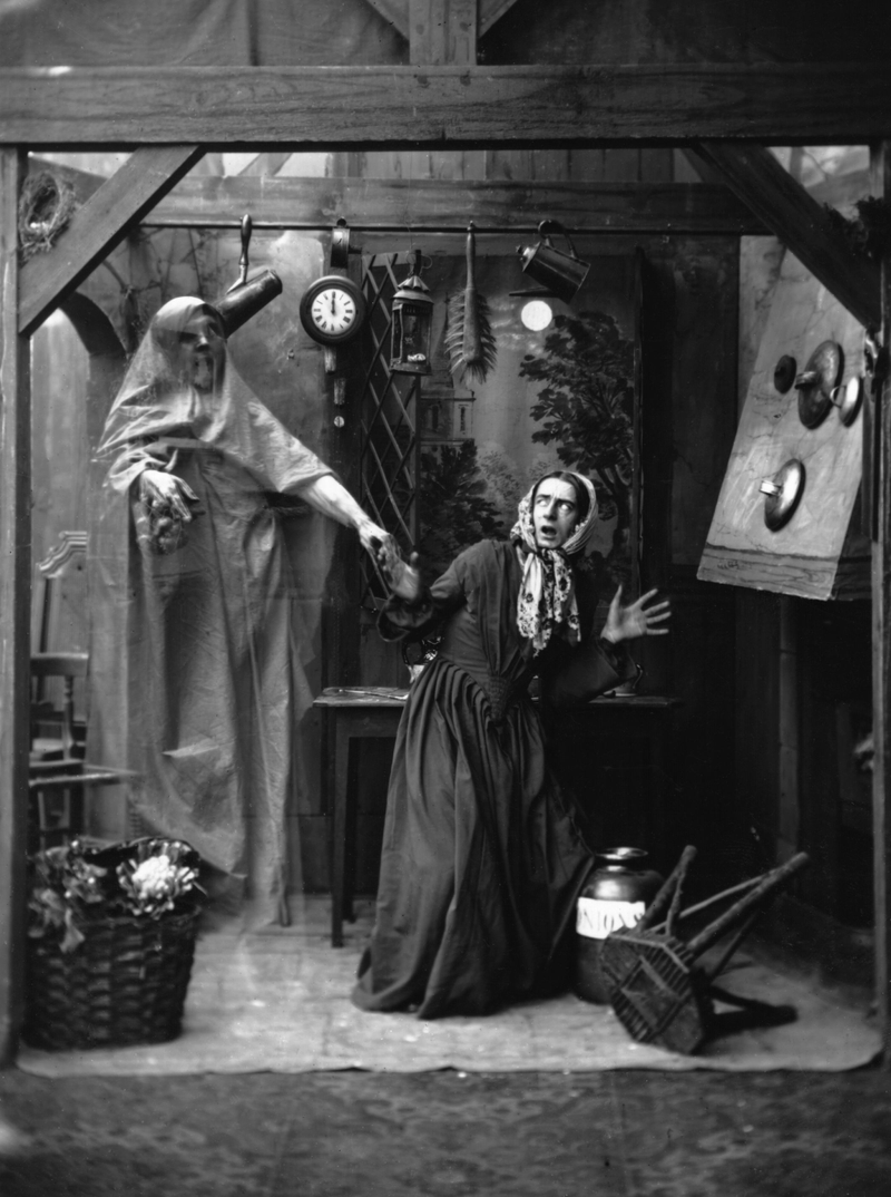 A set-up picture from the 1860s of a woman getting a scare from a transparent apparition appearing in her kitchen on the stroke of twelve. (Photo by Hulton Archive/Getty Images)